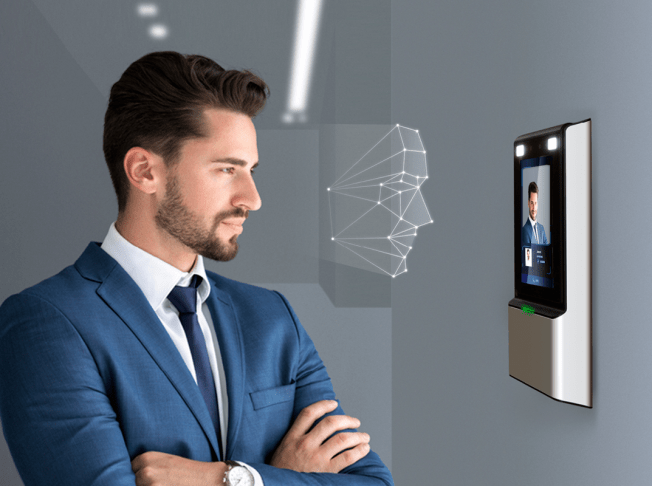 Man in suit looking at screen on wall